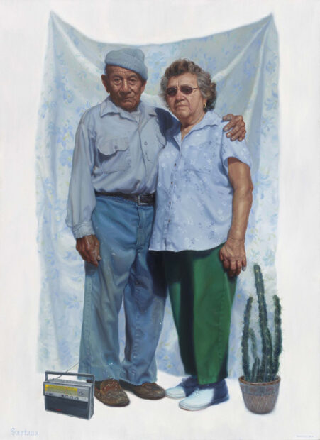 A large-scale painting by Vincent Valdez of his maternal grandparents. The older couple is dressed in mostly blue and stand close together. 