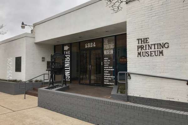 A photograph of the exterior of The Printing Museum in Houston.