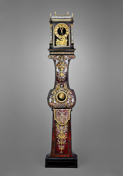 A long-case clock from the 17th century featuring ornate designs. 