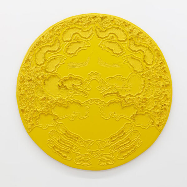 A photograph of a large mixed-media work on a circular panel by David-Jeremiah. The work uses rope to create designs and is covered in yellow enamel paint.