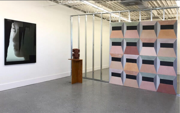 An installation image showing three works of art in a small gallery.