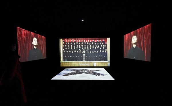 Installation image of a large scale three channel video installation