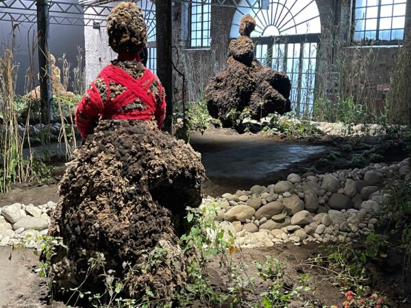 Installation of plants and figures made of dirt