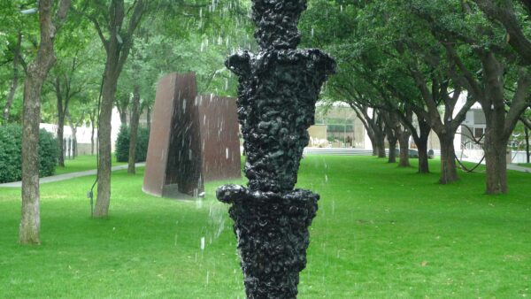 Photo of a towering fountain of water in a garden