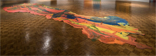 Installation image of a sculpture of spilled paint on a gallery floor