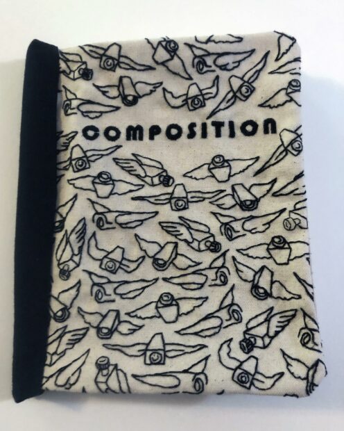 Photo of a fabric composition book embroidered by the artist