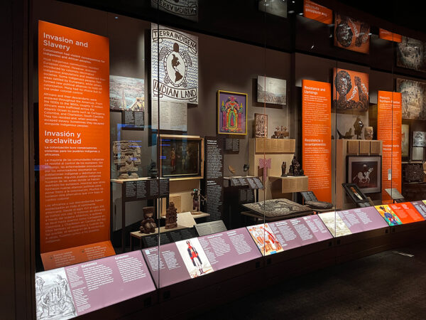 A view of a case filled with informational text and objects related to Latino history in the United States.