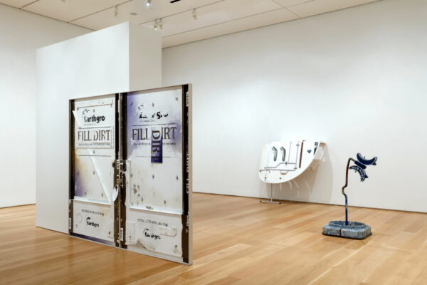 Installation view of a large scale sculpture and two smaller three dimensional works