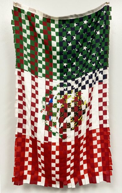 A fabric work by Tina Medina of a US and Mexico flag interwovern.