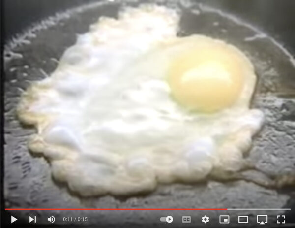 Video still of an egg being fried