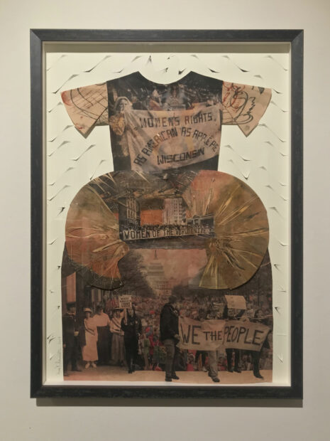 Work made with paper in the shape of a child's dress with protest imagery