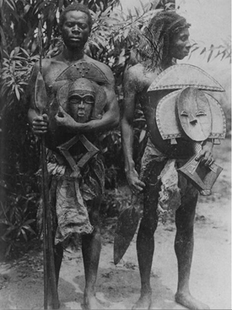 Photo of two people holding reliquary figures