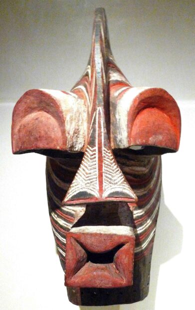 Frontal view of an African Mask with red, white and black detailing