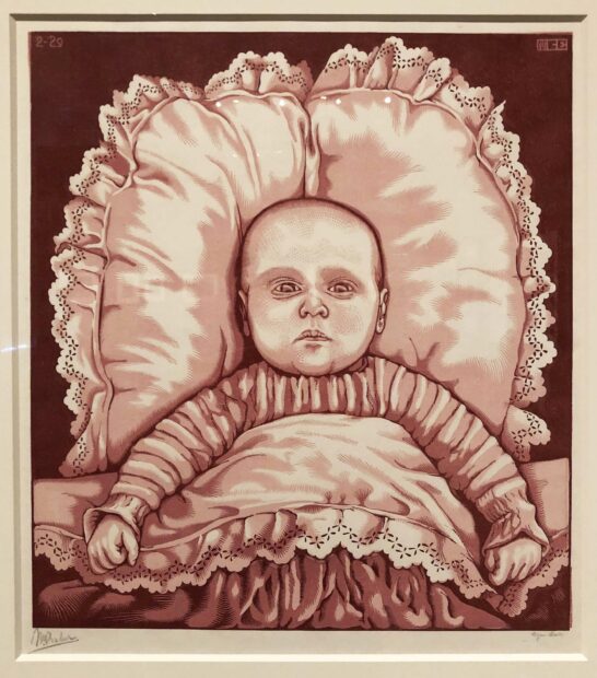 Woodblock print of an infant in red