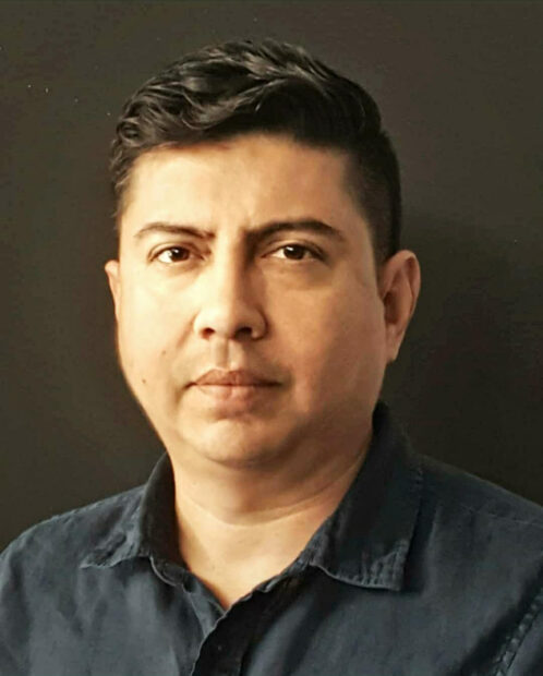 A headshot of artist and curator Gil Rocha. 