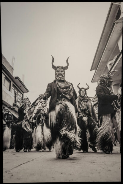Image of festival performers wearing fringe chaps and devil masks