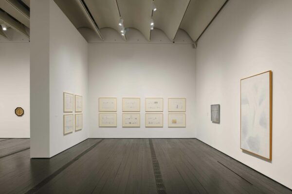 A photograph of an installation of paintings and sculptures in the Menil Collection in Houston.