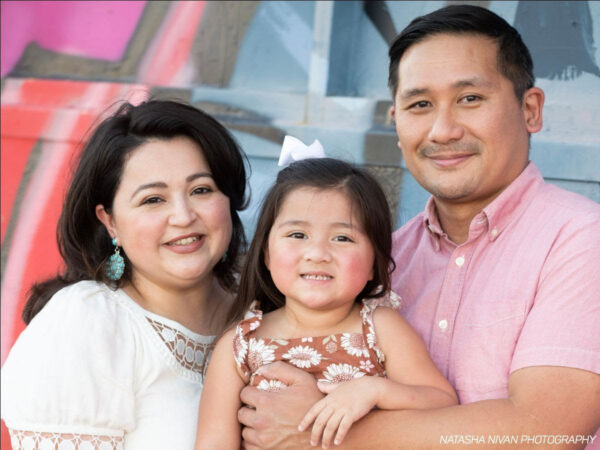 A photograph of artistic couple Laura Moreno and Azel Agustin with their child.