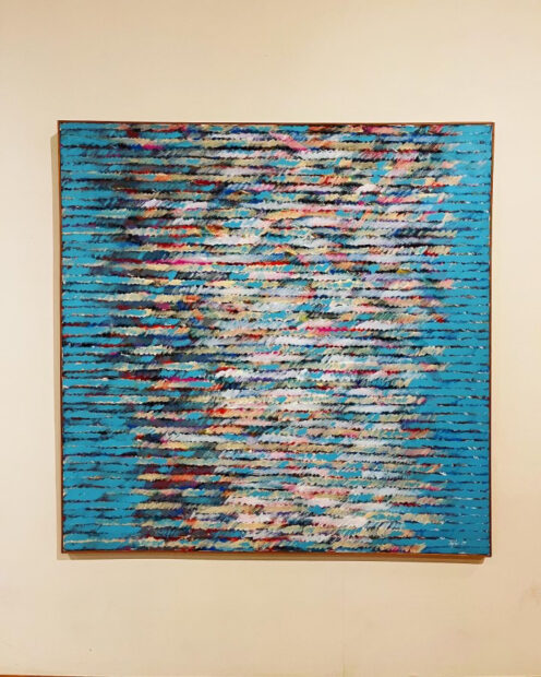 A painting featuring many abstract, horizontal lines of bright colors.