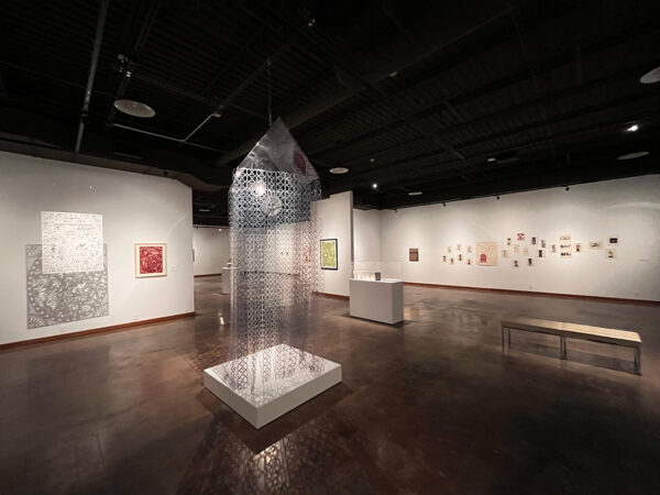 An installation image of "Finding Your Voice: Café Con Leche Co-Curates" at the Wichita Falls Museum of Art.
