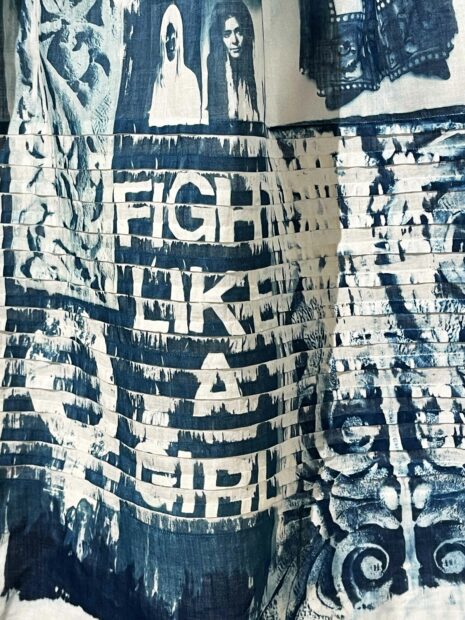 Detail of a dress made of cyanotype with the words "Fight like a Girl"