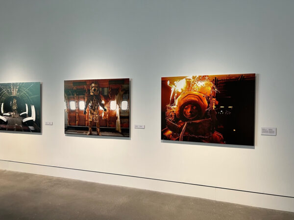 Installation view of three photos depicting astronauts