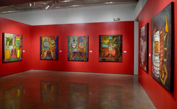 Installation view of large scale paintings on a red wall