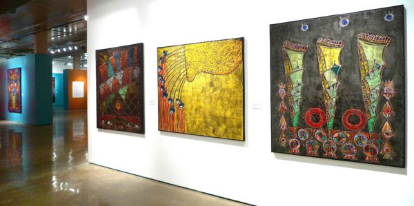 Installation view of large scale works on white, turquoise and orange walls