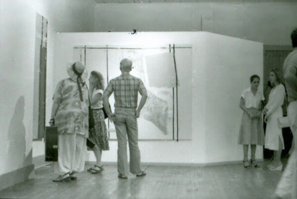 Antique installation shot of visitors in an exhibition