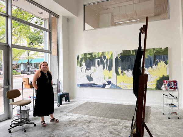 Painter Ariel Davis stands in front of a large-scale work in progress in her studio.
