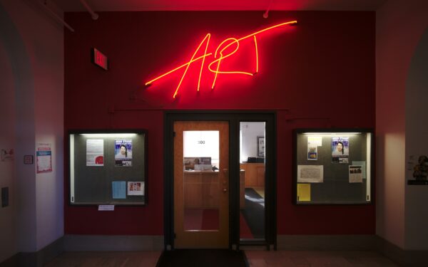 A large neon sign that reads "ART" is displayed above a doorway.