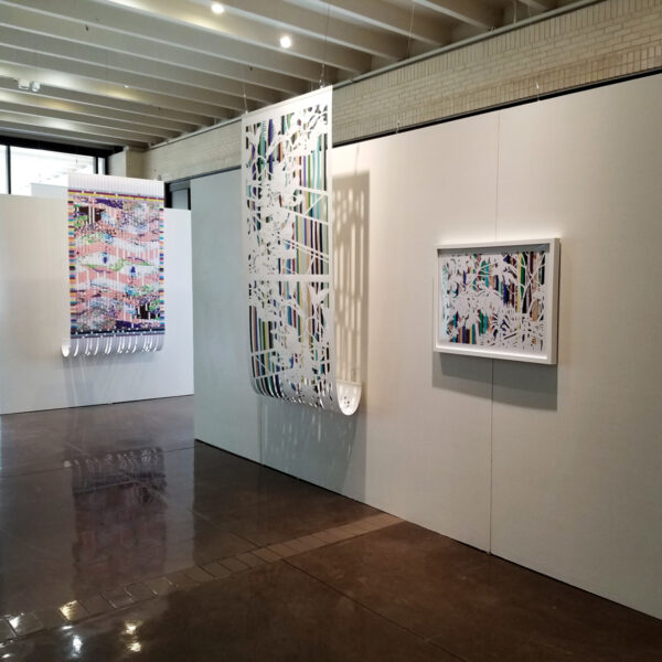 An installation image of three abstract works in a white gallery space.