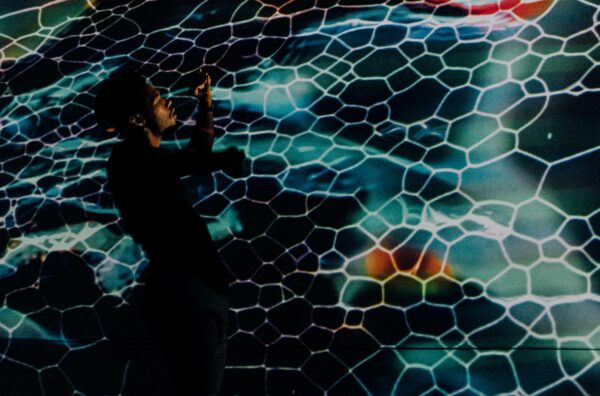 Viewer interacting with an interactive projection