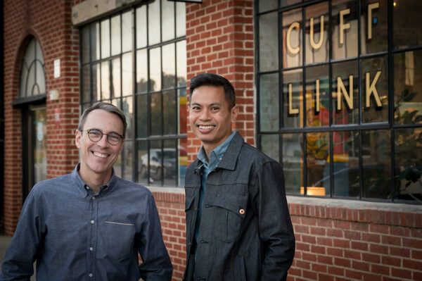 A photograph of partners Doug Gault and Joey Luong outside of Cufflink Gallery.