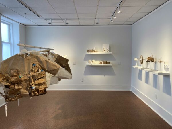 installation view of wearable objects in a white cube gallery space