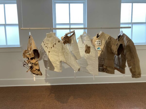 Installation view of wearable jackets made from cardboard