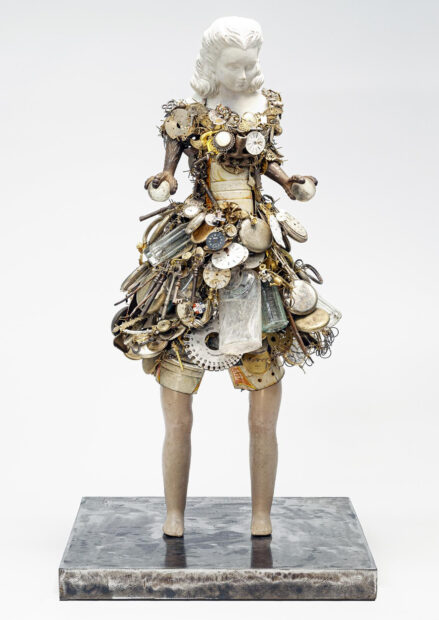 A sculpture of a female figure constructed from an array of found objects. Artwork by Karin Broker.