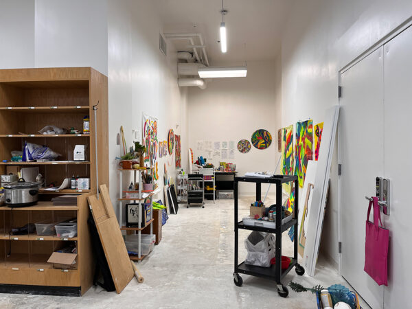 Muralist Mariell Guzman's studio with several works in progress displayed.