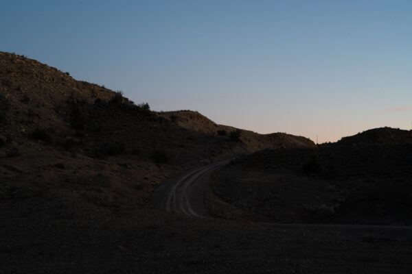 Photo of sun setting on a windy and empty road