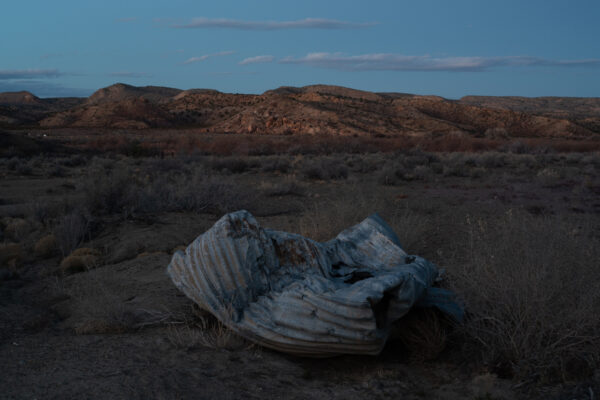 Photo of detritus on the side of the road in a desert landscape