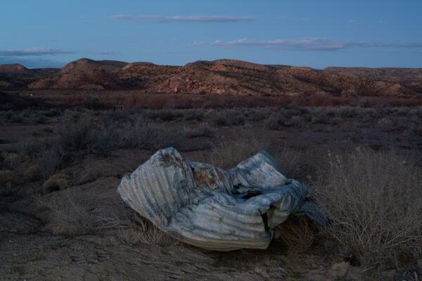 Detritus on the side of the road in a desert landscape