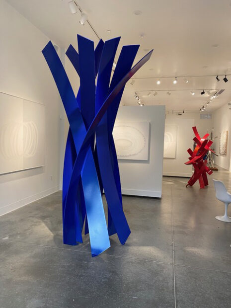 Installation view of a large scale steel sculpture that looks like it's unraveling