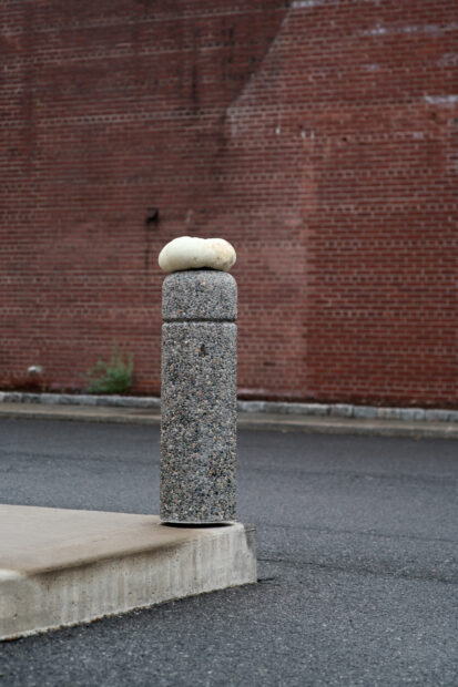 Photo of a pumpkin on top of a concrete post