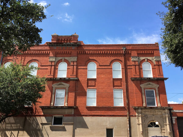A photograph of the exterior of a red brick building.