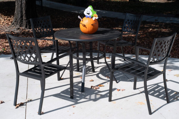 Photo of a pumpkin decoration on an outdoor table.