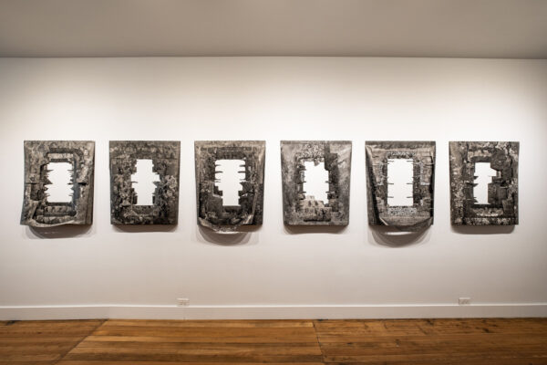 Six large scale black and white rectangular objects on a wall