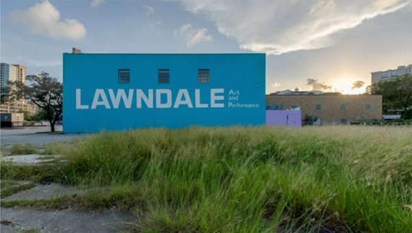 A photograph of the exterior of the Lawndale Art Center building and a grassy adjacent property that the organization recently purchased.