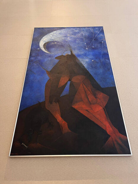 A photograph of the large-scale painting "El Hombre" by Rufino Tamayo. The artwork hangs on the wall so the photograph appears distorted.