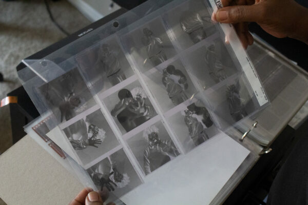 Shawnequa Linder displays a binder of photo film and slides