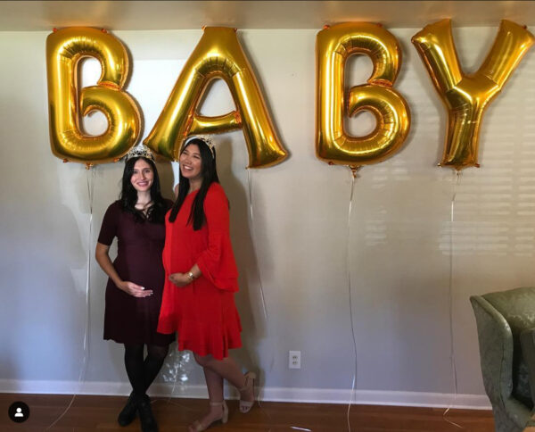 Two women posed at a baby shower